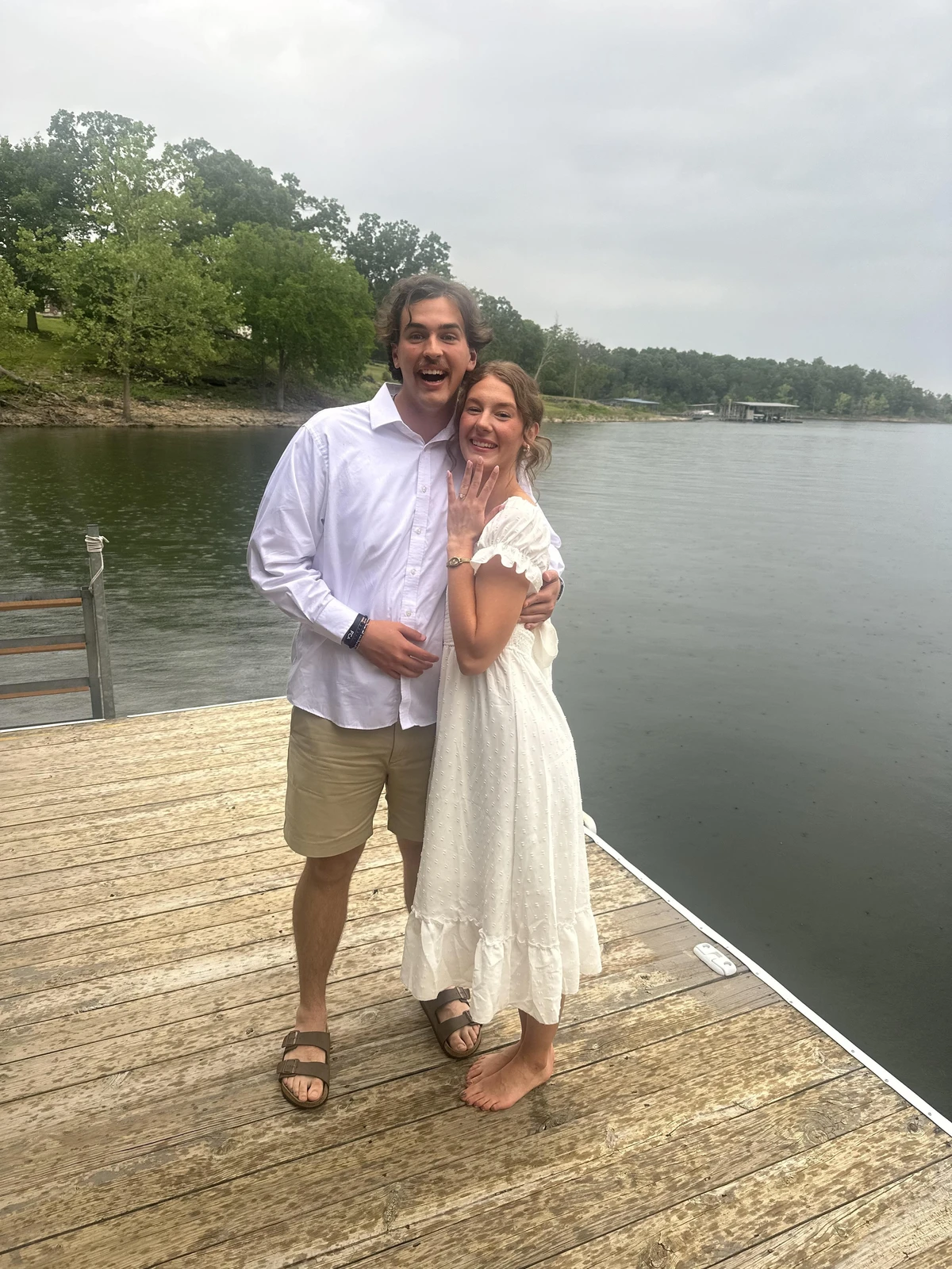 A man and woman standing on a dock.